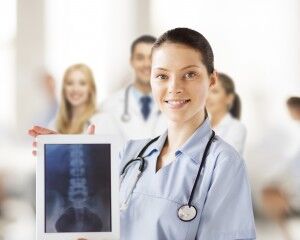 female doctor with x-ray on tablet pc