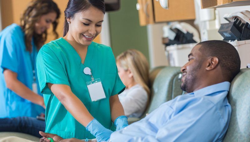 African American businessman donates blood during lunch break
