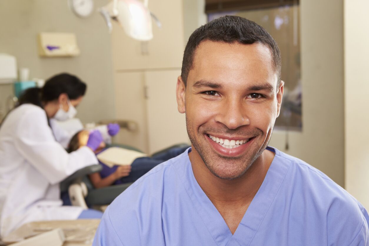 Smiling dental nurse at an open dentist’s surgery