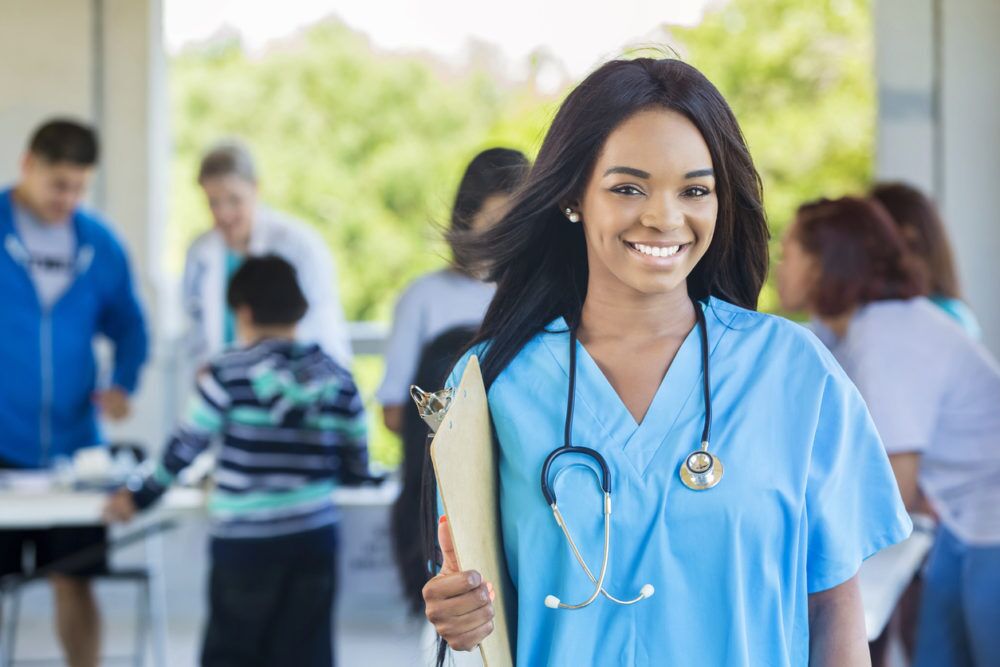 Smiling African American Nurse with a clipboard and stethoscope Is an LVN Program Right for You?